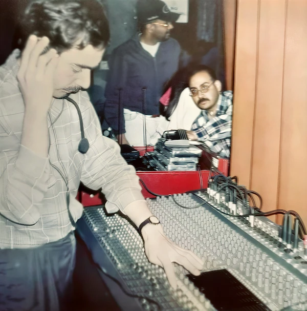 Rock Sound engineer operating a large-format analog mixing console during the analog era of live audio production