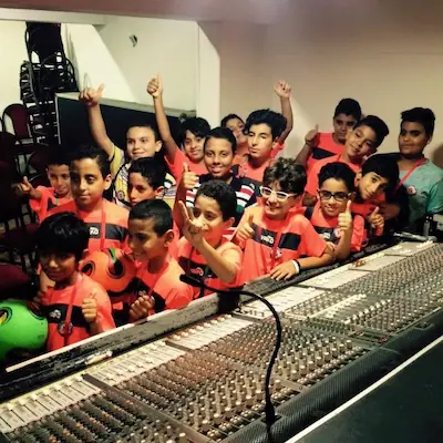Professional audio engineer operating a mixing console during a Coptic Orthodox church live service — Rock Sound live sound production in worship environment